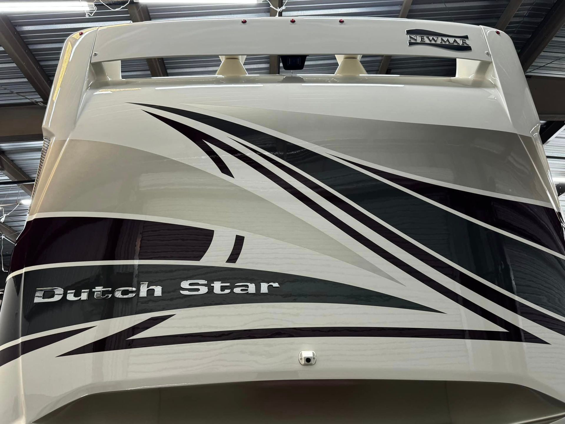 A dutch star boat is sitting in a warehouse with Bob Moses ceramic coating, Sensha World Crystal Glow