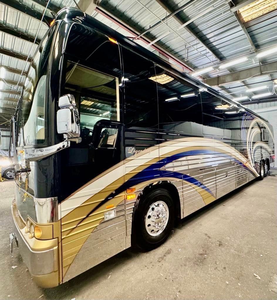 A large bus is parked in a warehouse with Bob Moses ceramic coating, Sensha World Crystal Glow