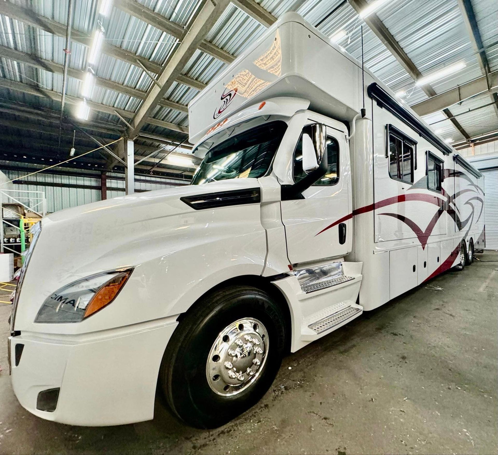 A large white truck is parked in a garage with Bob Moses ceramic coating, Sensha World Crystal Glow