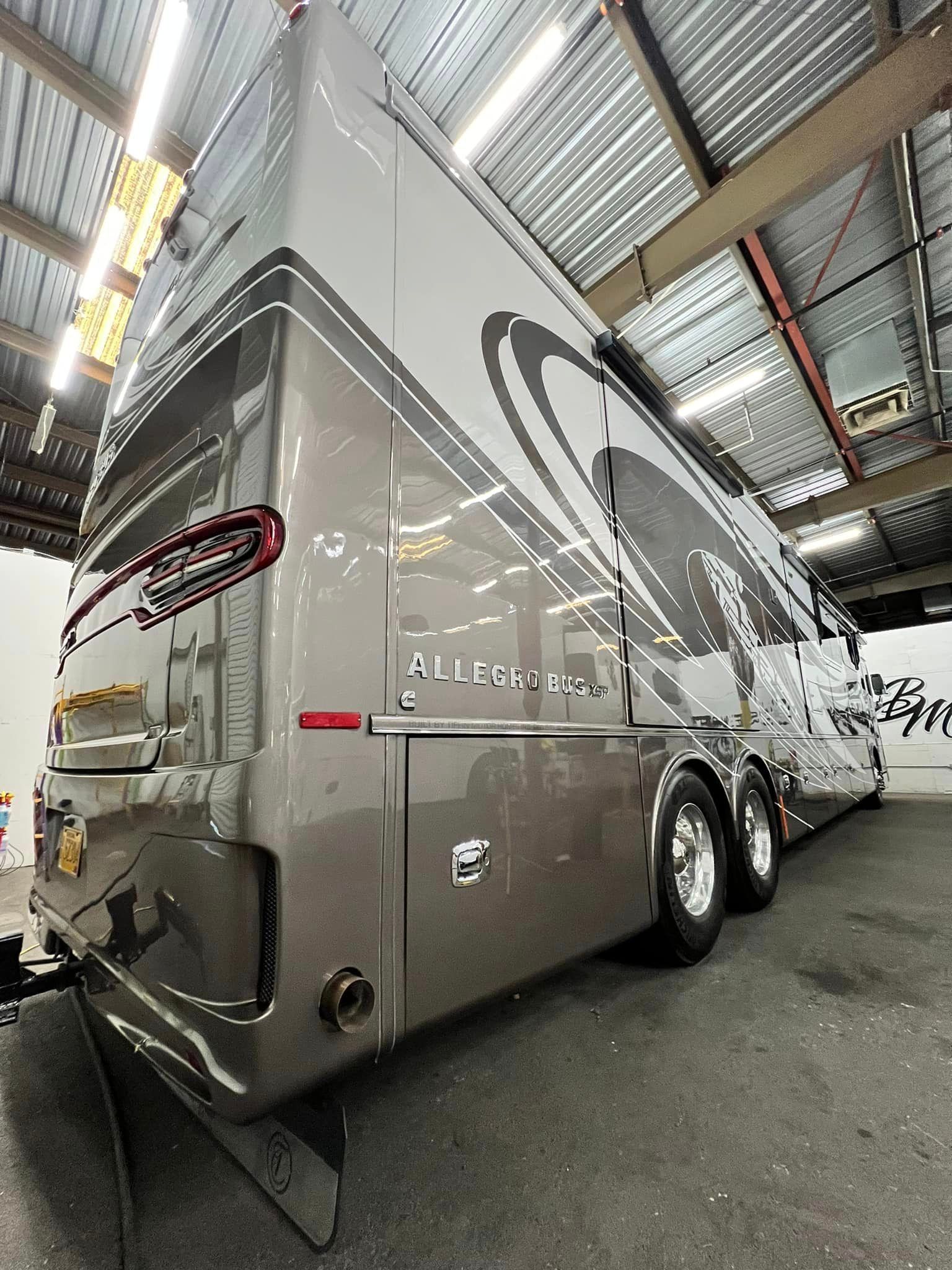 A large rv is parked in a garage with Bob Moses ceramic coating, Sensha World Crystal Glow