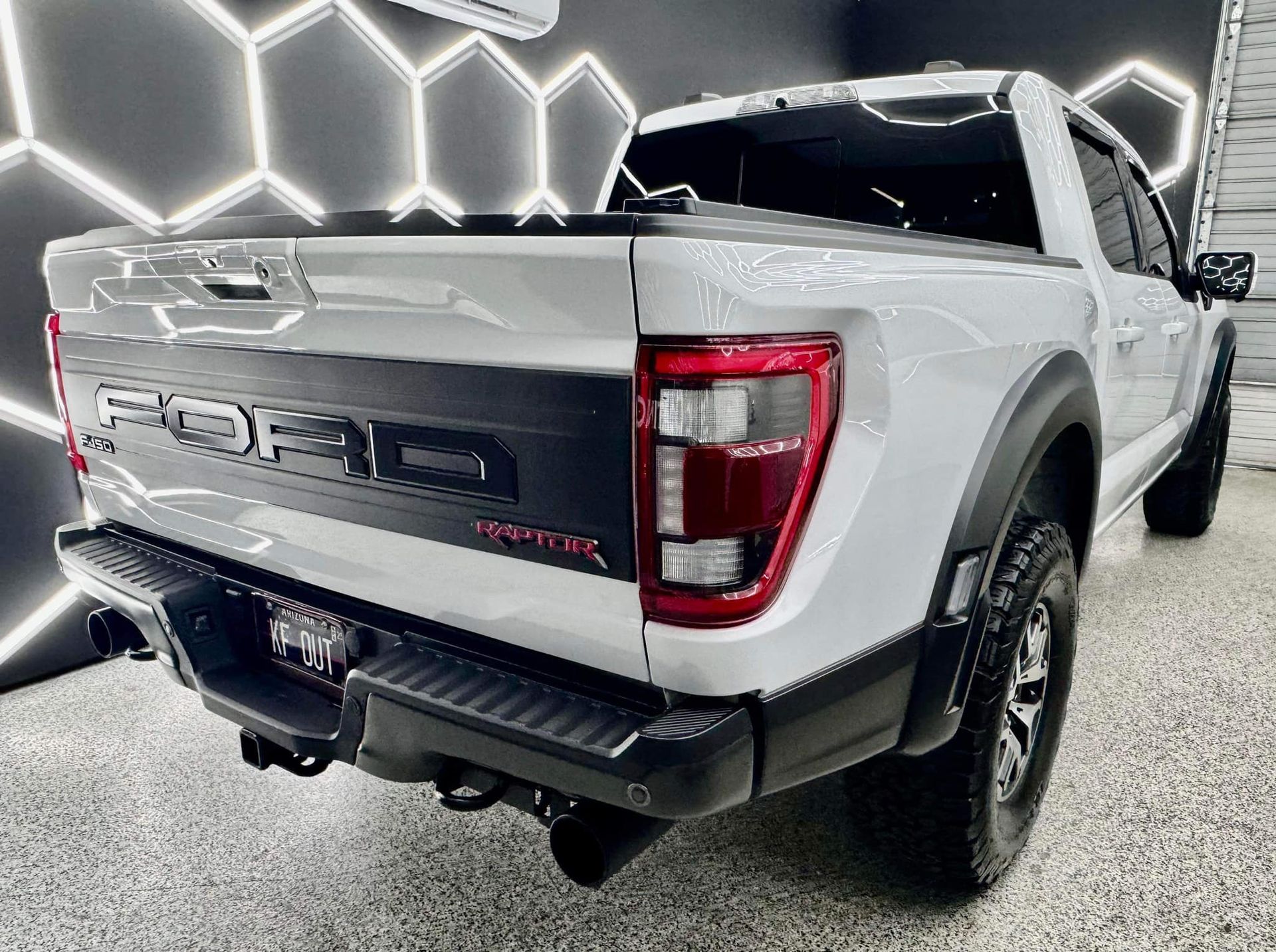 A white ford raptor truck is parked in a garage with Bob Moses ceramic coating, Sensha World Crystal Glow