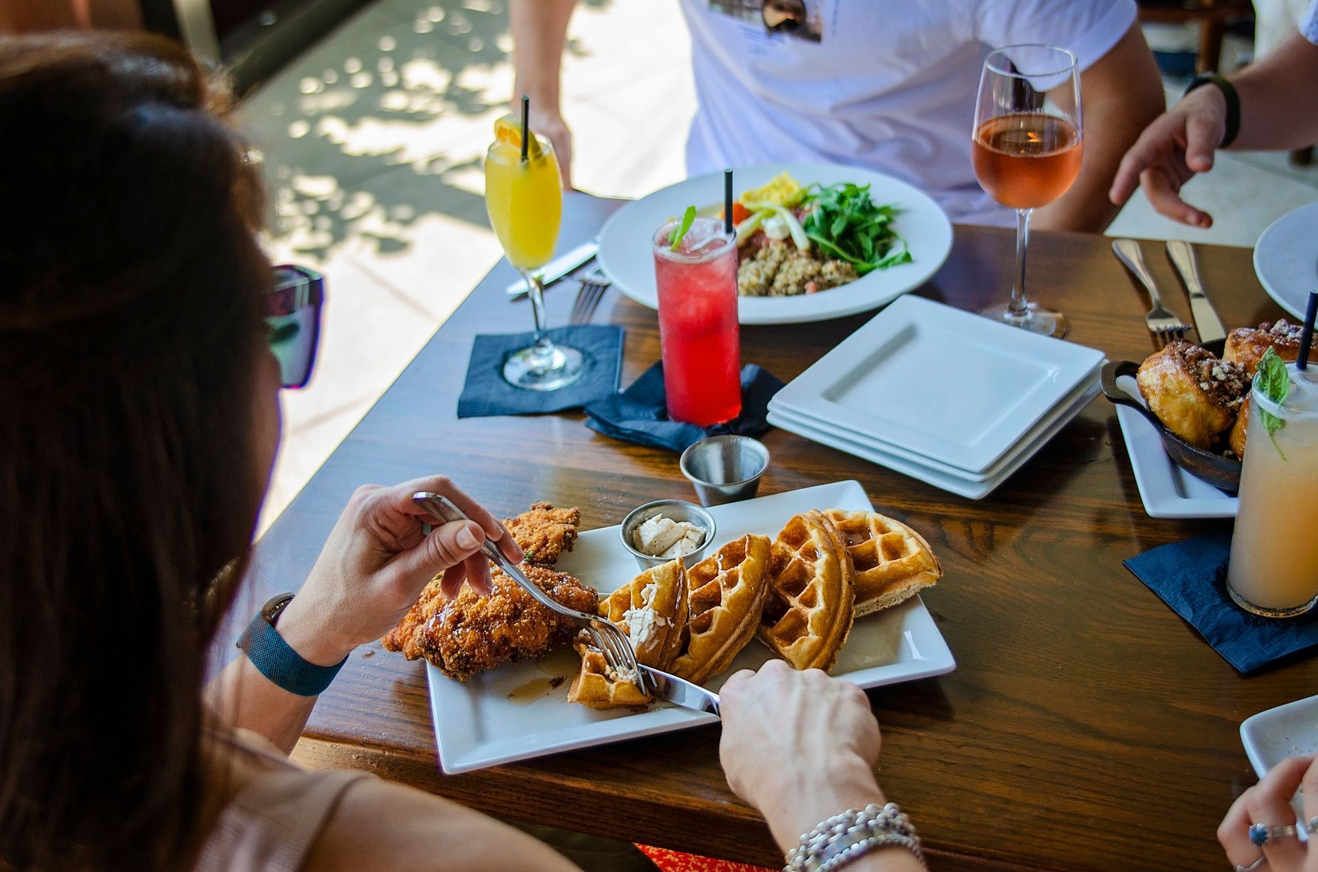 A group of people are sitting at a table eating food.
