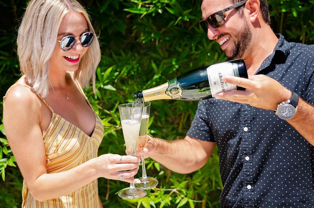 A man is pouring champagne into a woman's glass.