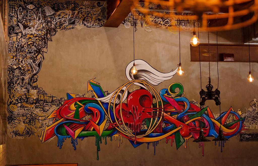 There is a large mural on the wall of a building.