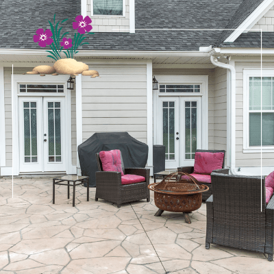 a patio with wicker furniture and a fire pit in front of a house .
