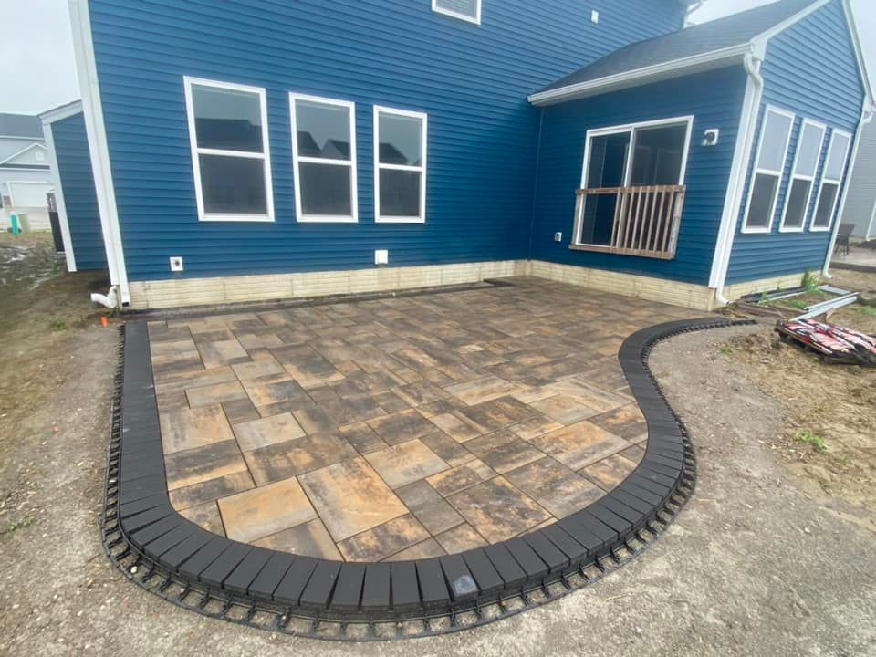 a blue house with a patio in front of it .