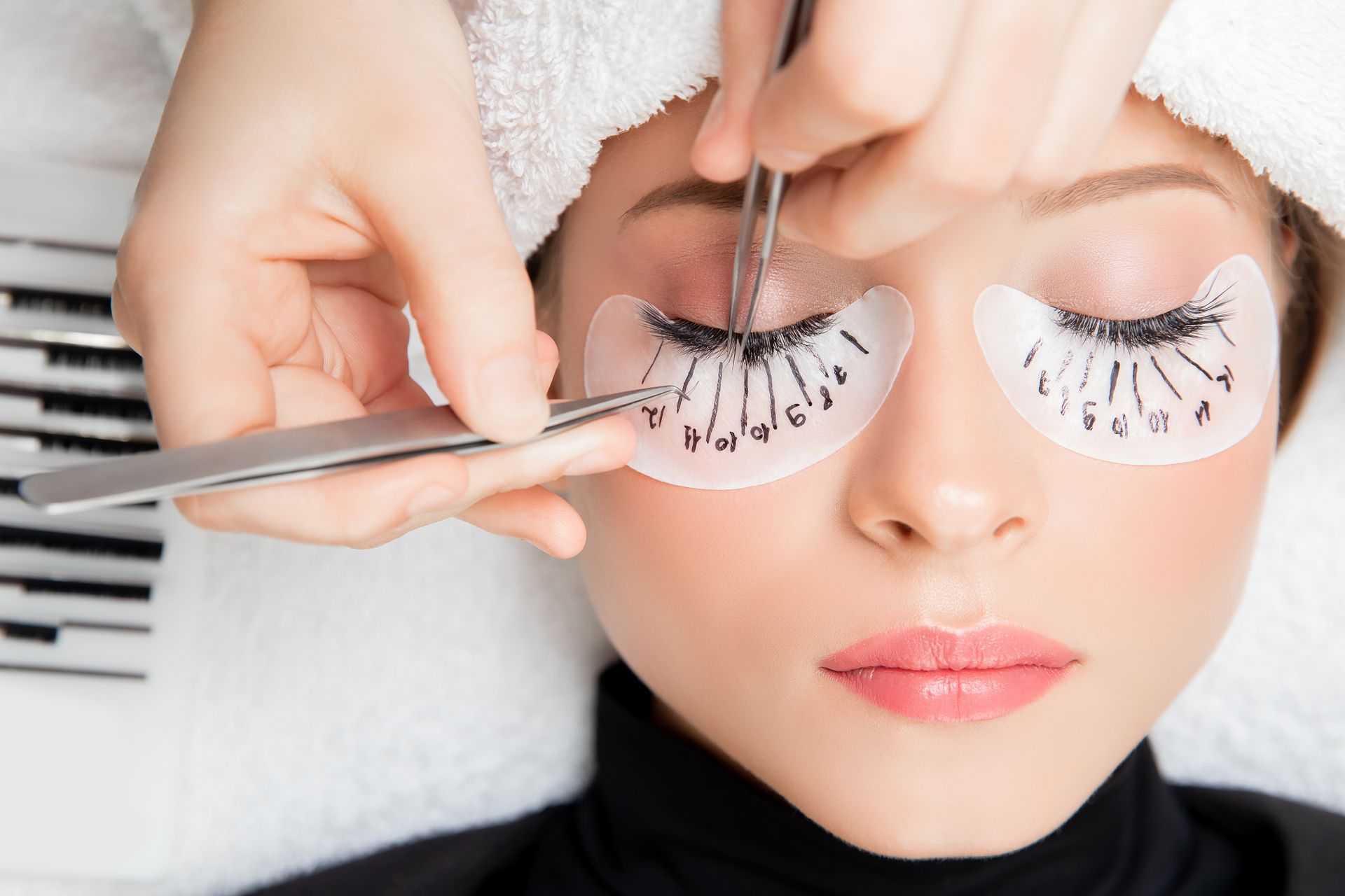A woman is getting her eyelashes done at a beauty salon.