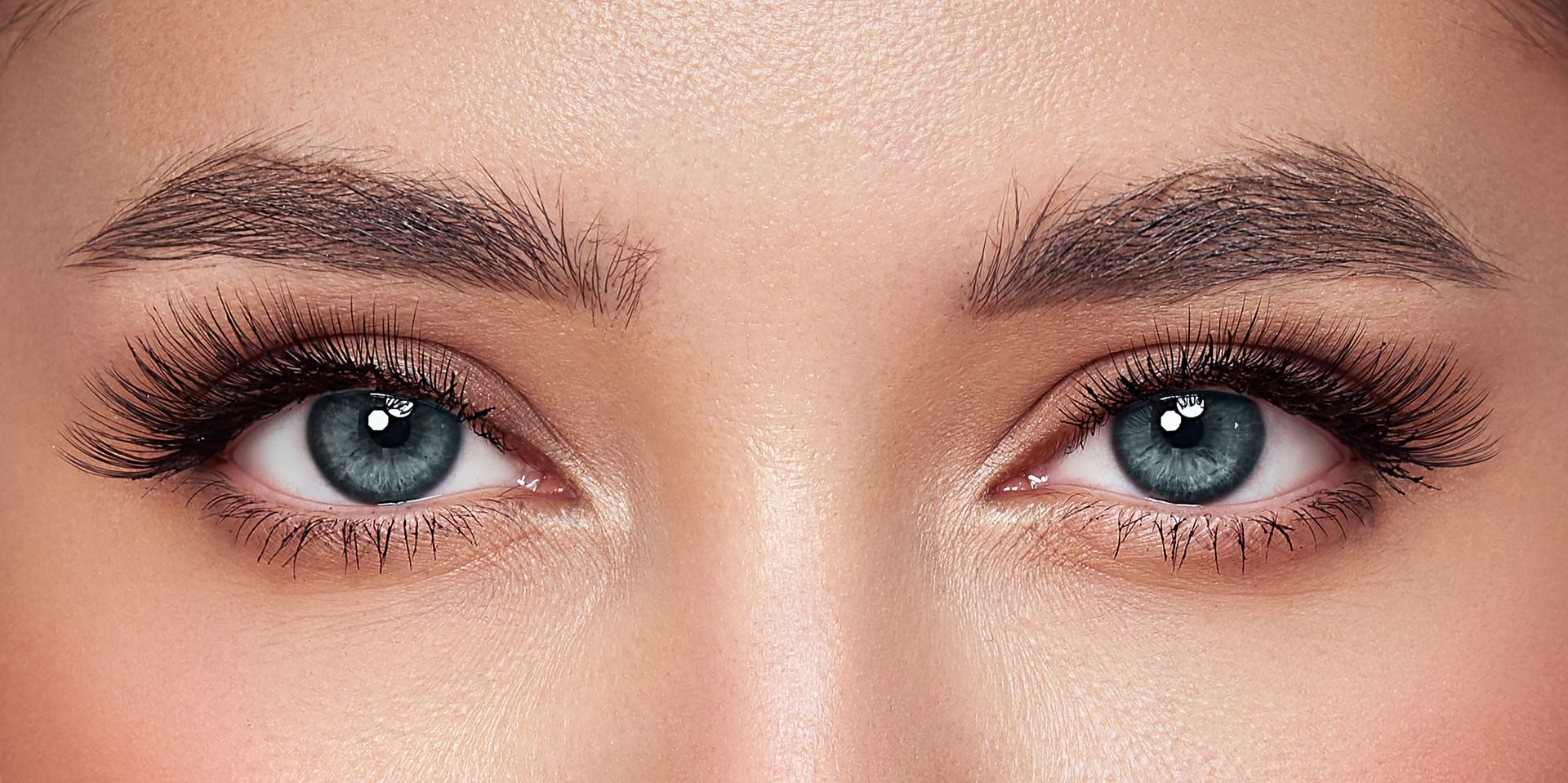 A close up of a woman 's eye with eye patches on it.
