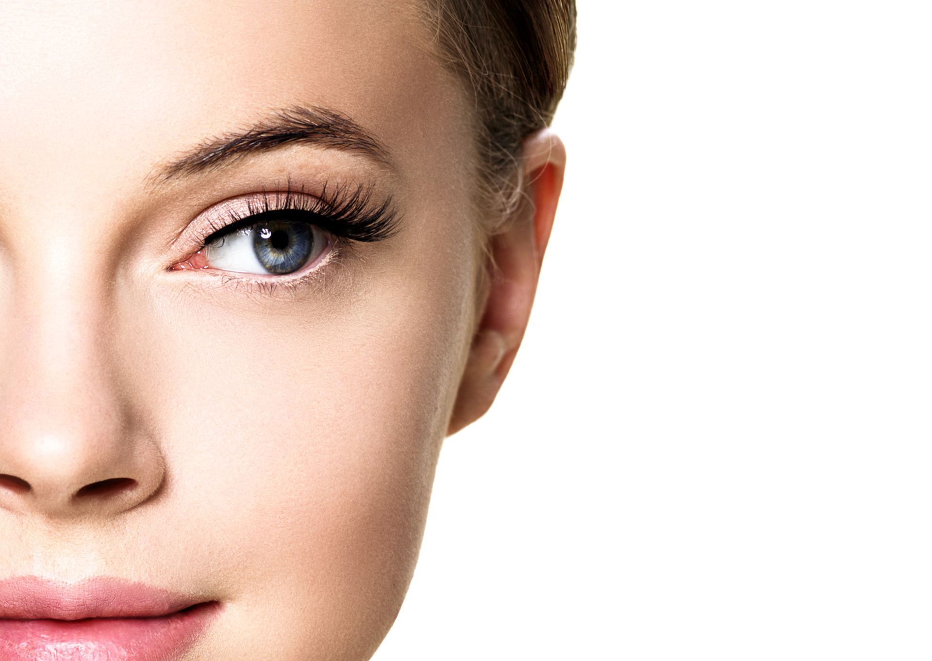 A close up of a woman 's face with long eyelashes on a white background.