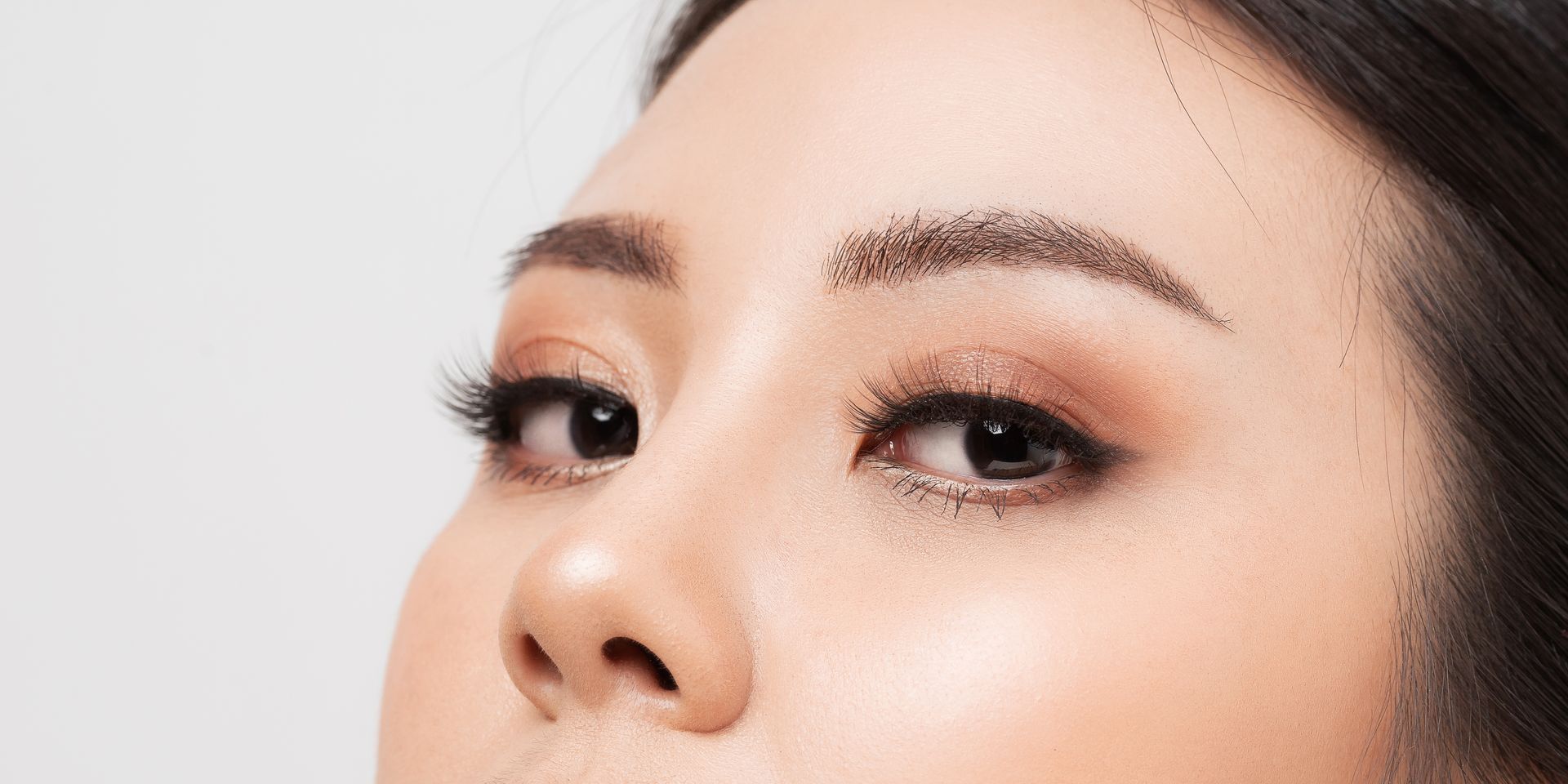A close up of a woman 's face with makeup on.