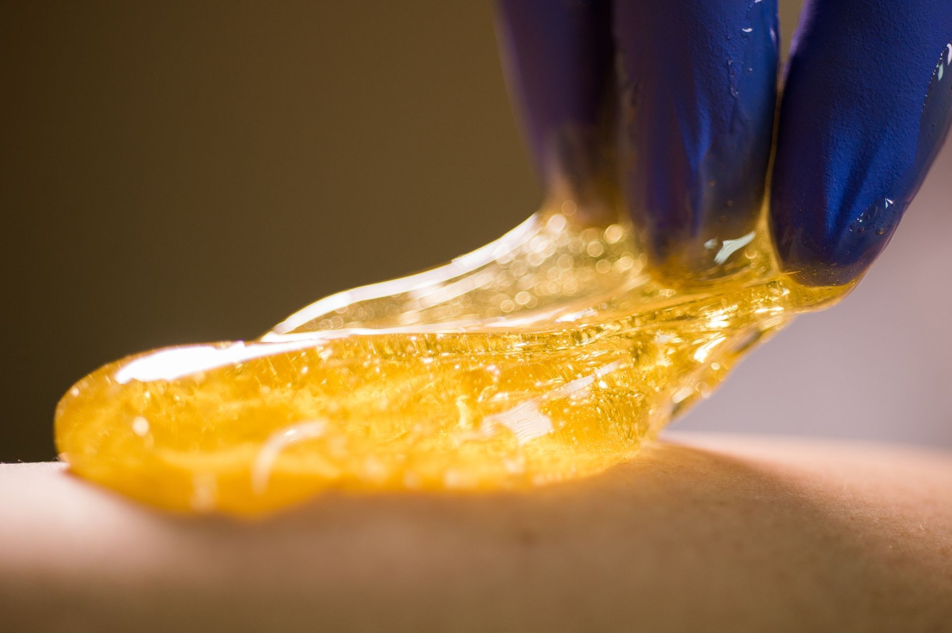 A person is applying wax to another person 's skin.