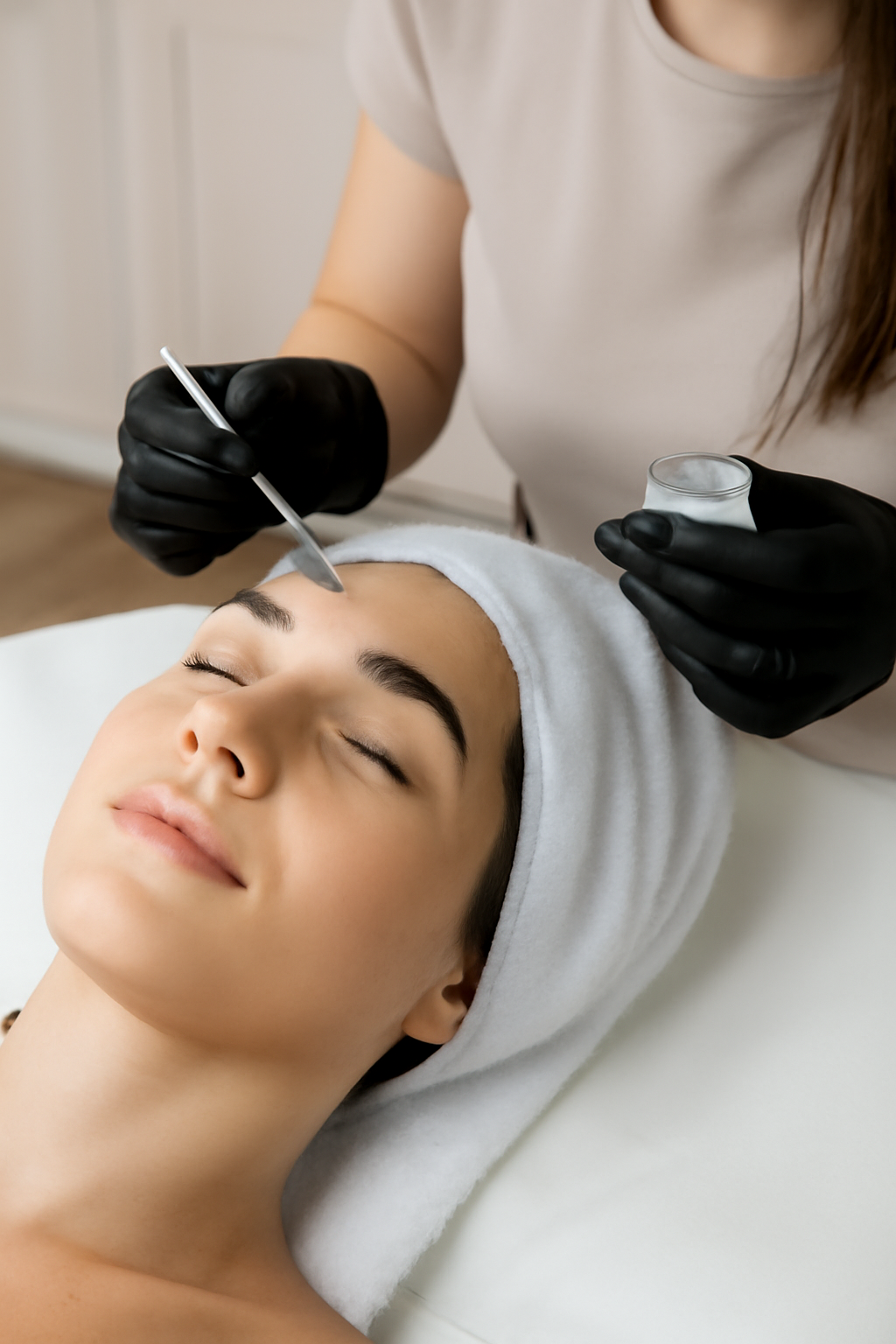 Bare Elegance technician applying brow lamination solution with precision in a professional studio.