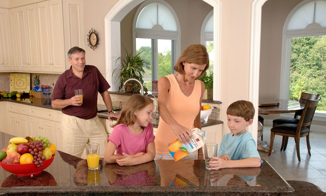 Family enjoys clean cool air conditioned kitchen