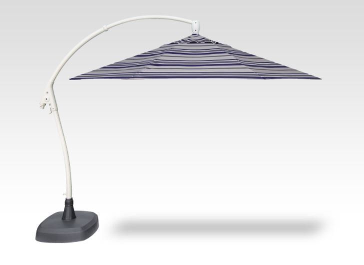 A striped umbrella is sitting on a white surface.