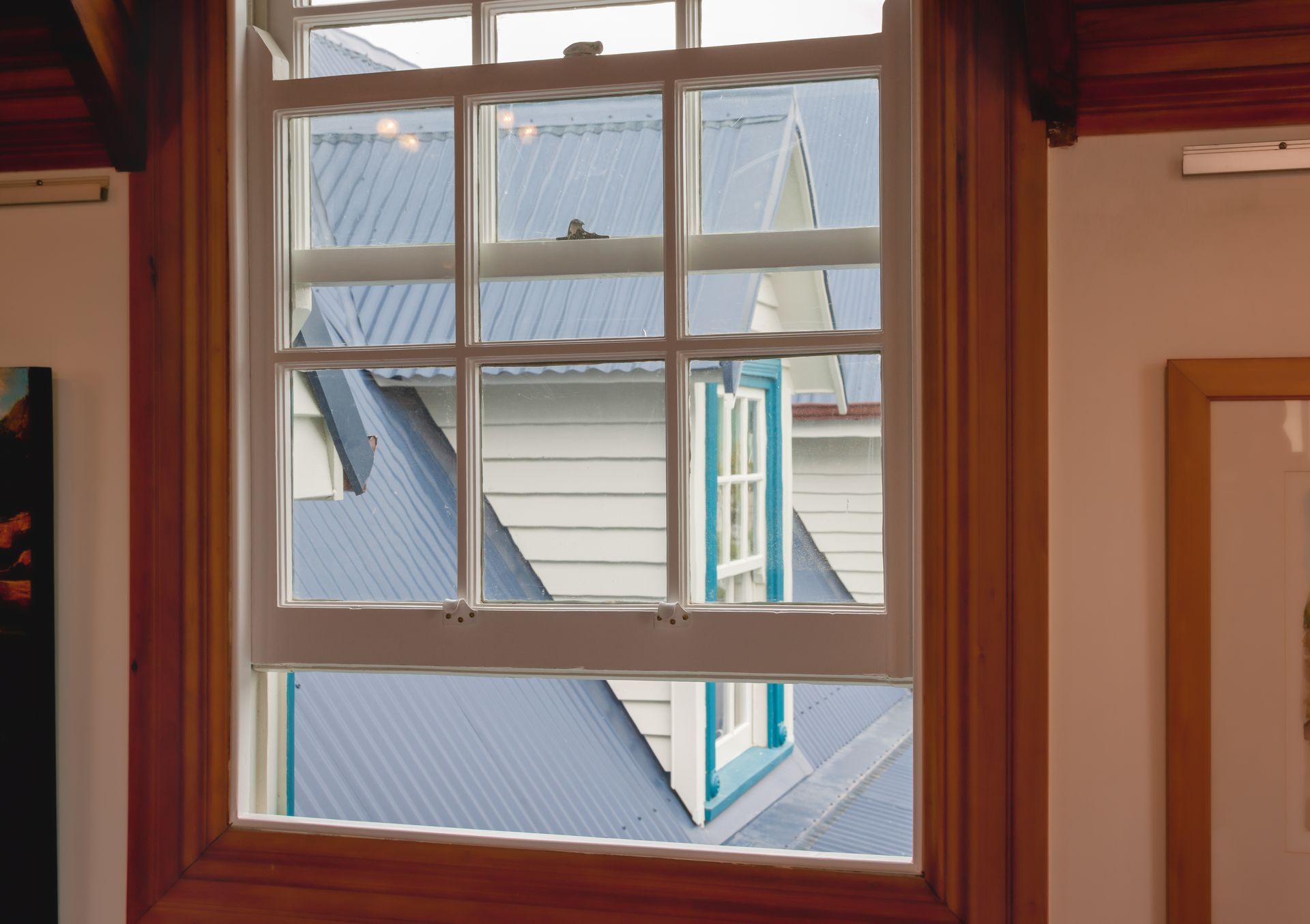 A window in a room with a blue roof