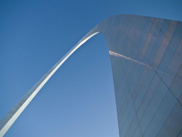 Looking up at the St. Louis Gateway Arch with a blue sky in the background