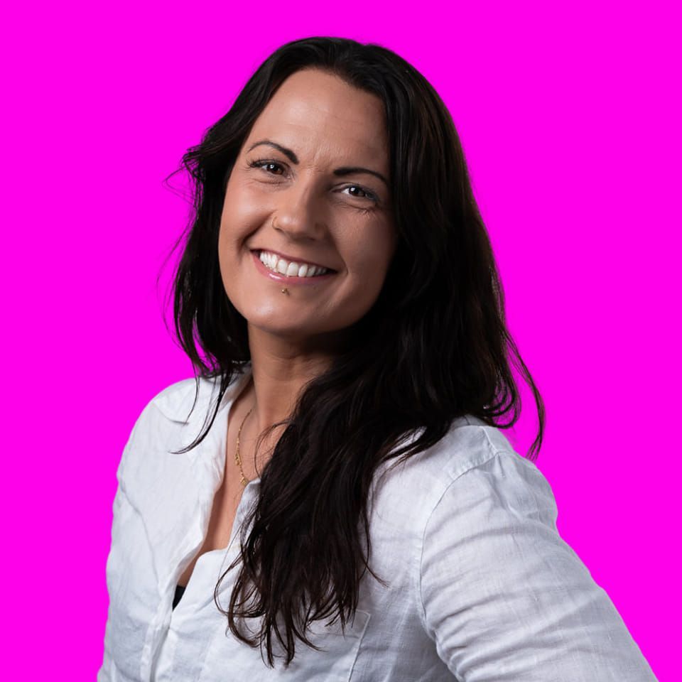 A Woman in a White Shirt is Smiling in Front of a Pink Background —Mind Breath Soul In Byron Bay, NSW