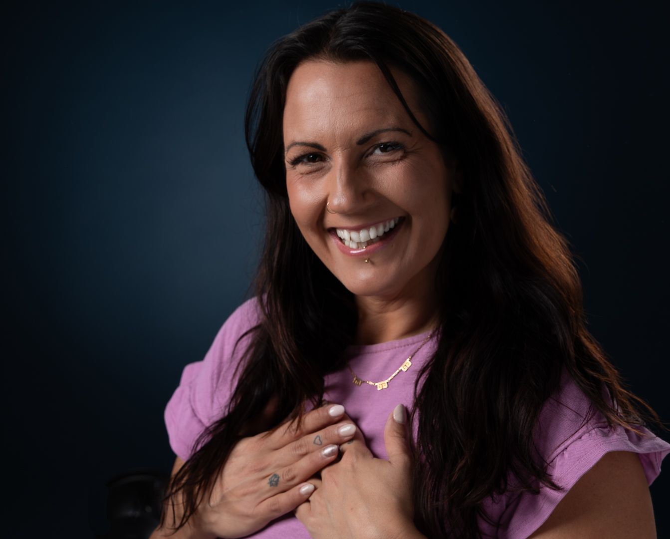 A Woman Wearing A Necklace Is Smiling —Mind Breath Soul In Byron Bay, NSW
