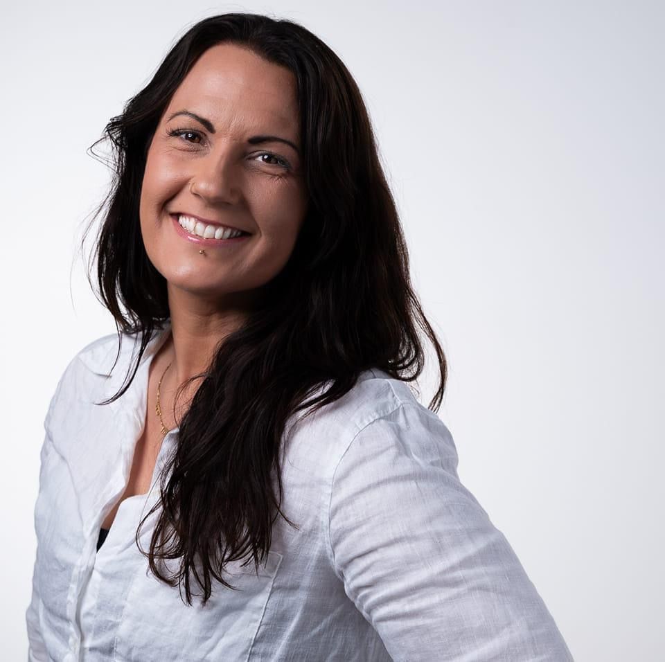 A Woman With Long Dark Hair Is Smiling And Wearing A White Shirt —Mind Breath Soul In Byron Bay, NSW