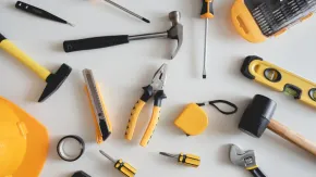 An array of yellow tools arranged on a white table