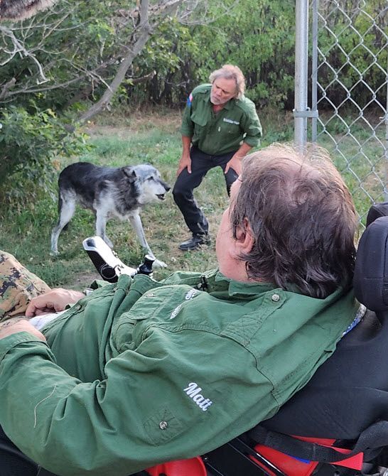 Matt and Troy Paproski howling with their wolf Timber