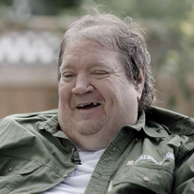 Troy Paproski smiling during an interview.