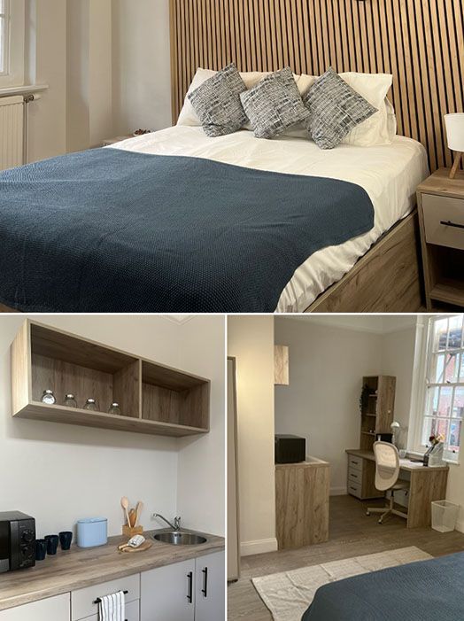 A bedroom with a bed , desk and chair.