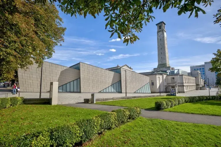 A large building with a clock tower in the background