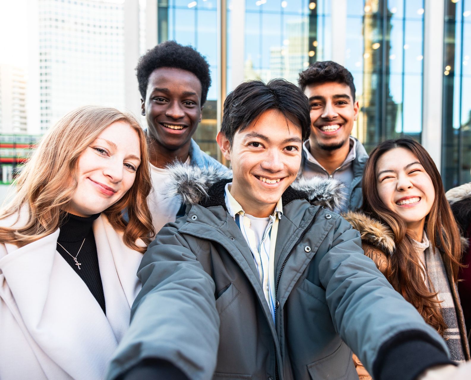 A group of young people are taking a selfie together.
