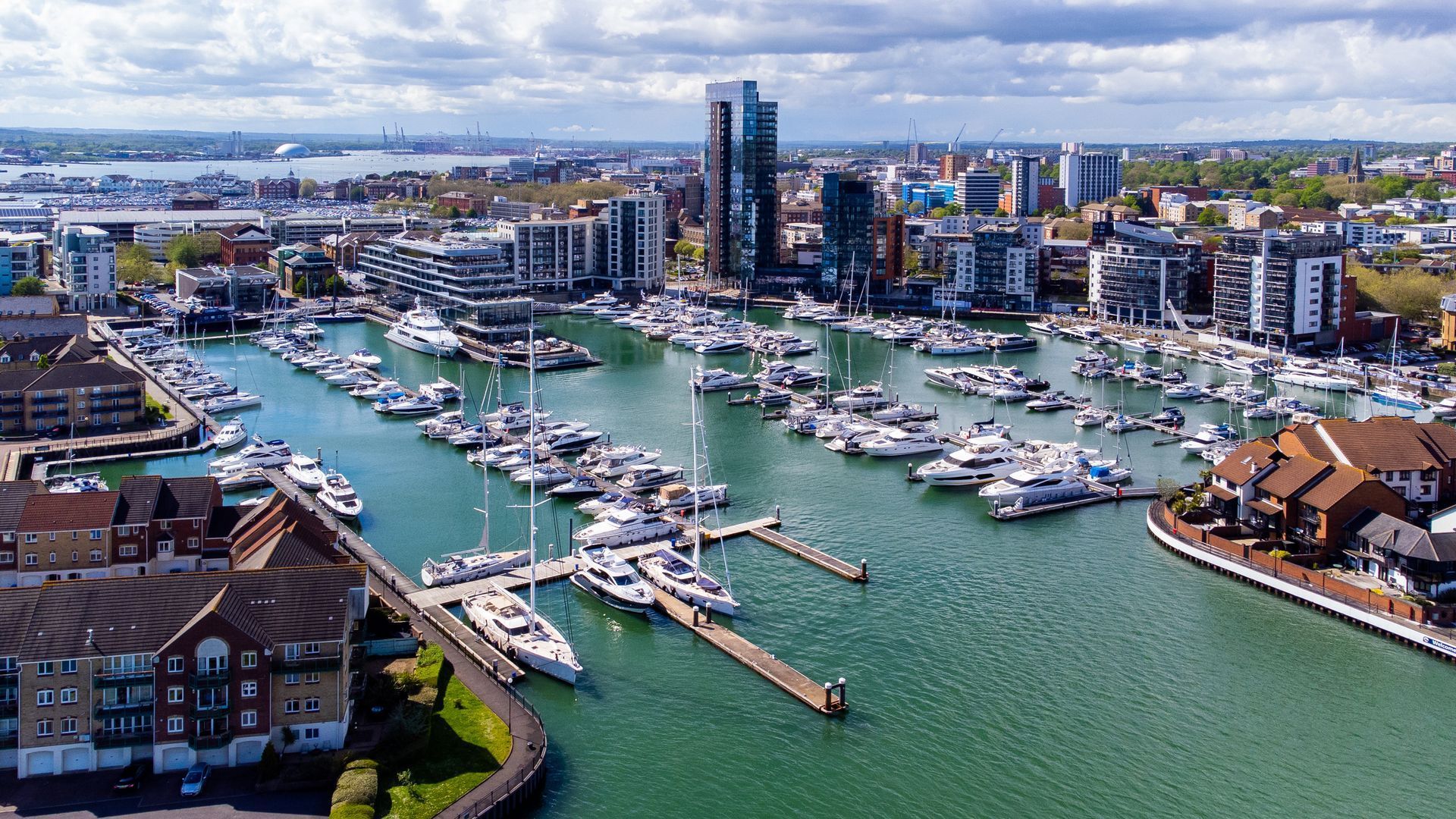 An aerial view of a marina filled with boats and buildings.