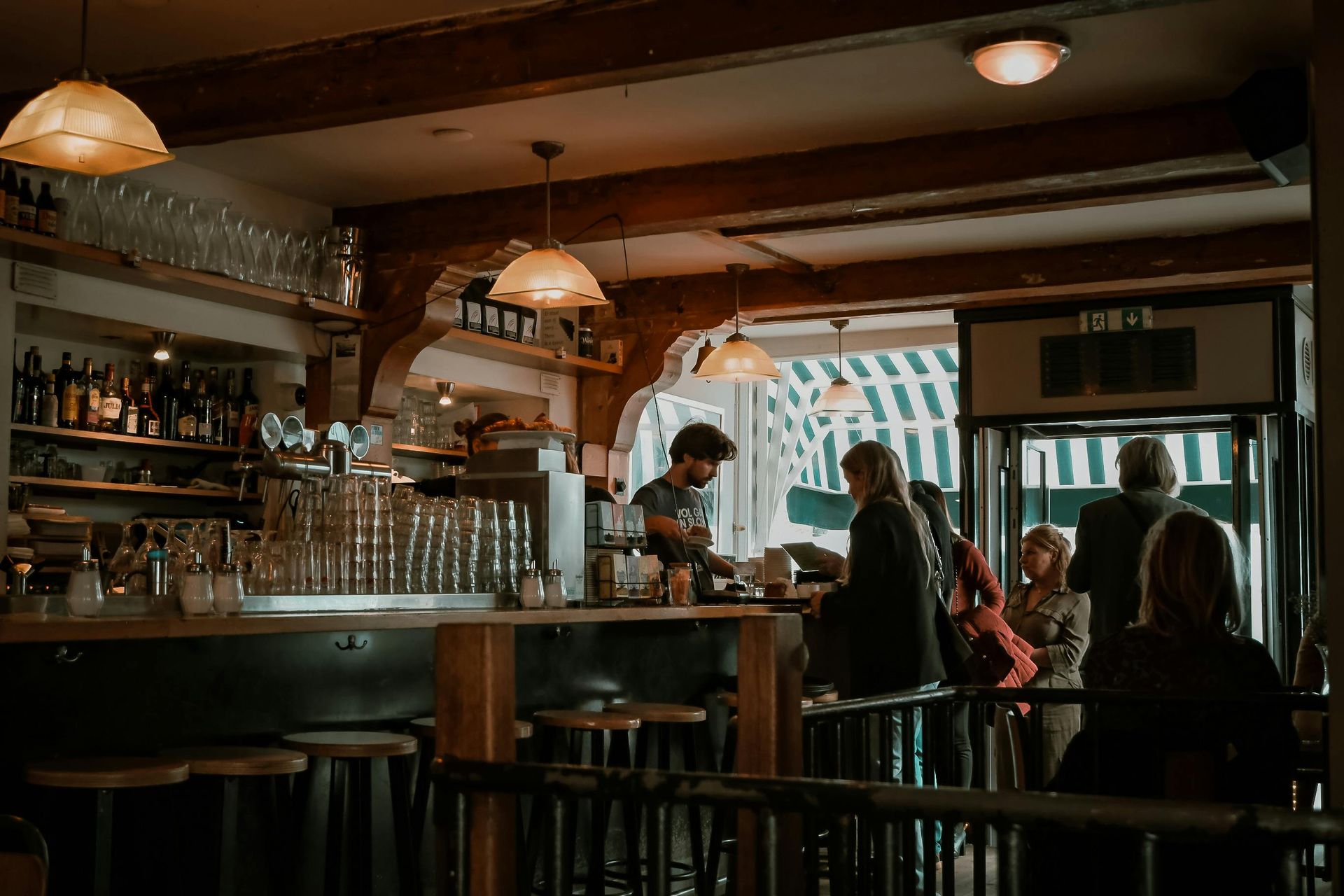 A group of people are sitting at tables in a restaurant.