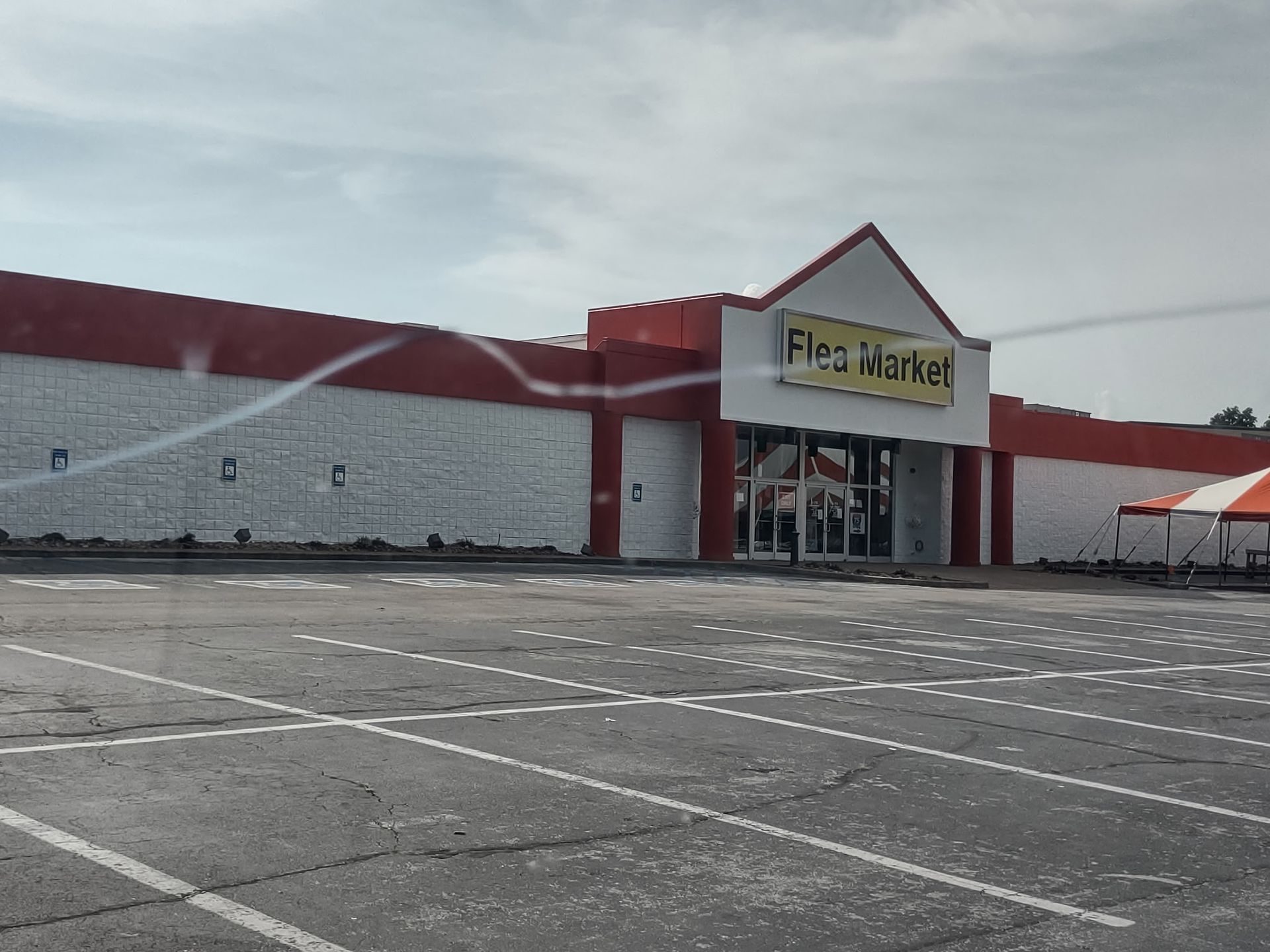 An empty parking lot in front of a flea market