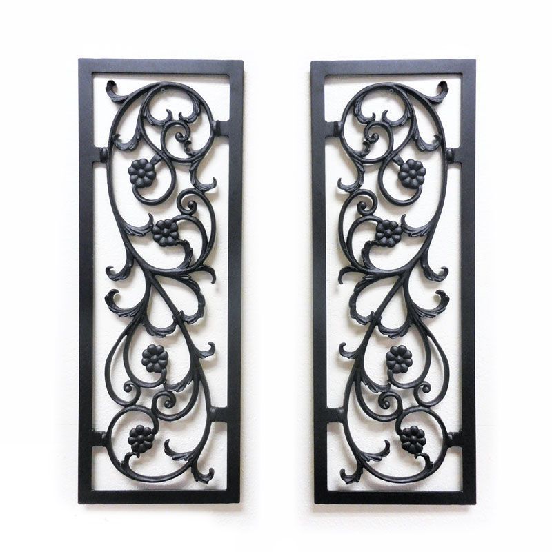 A pair of wrought iron panels with a floral design on them