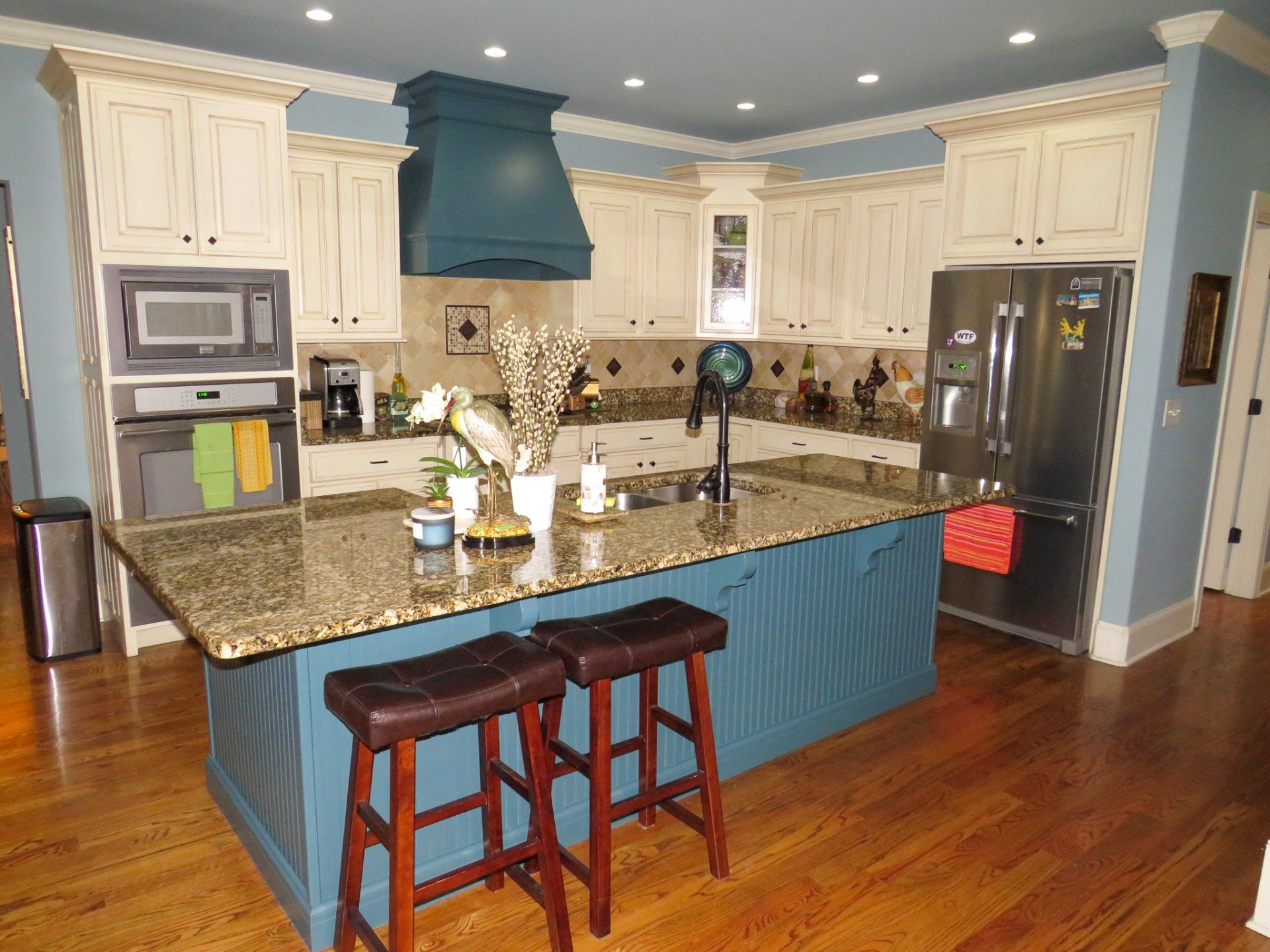 A kitchen with a large island and stools