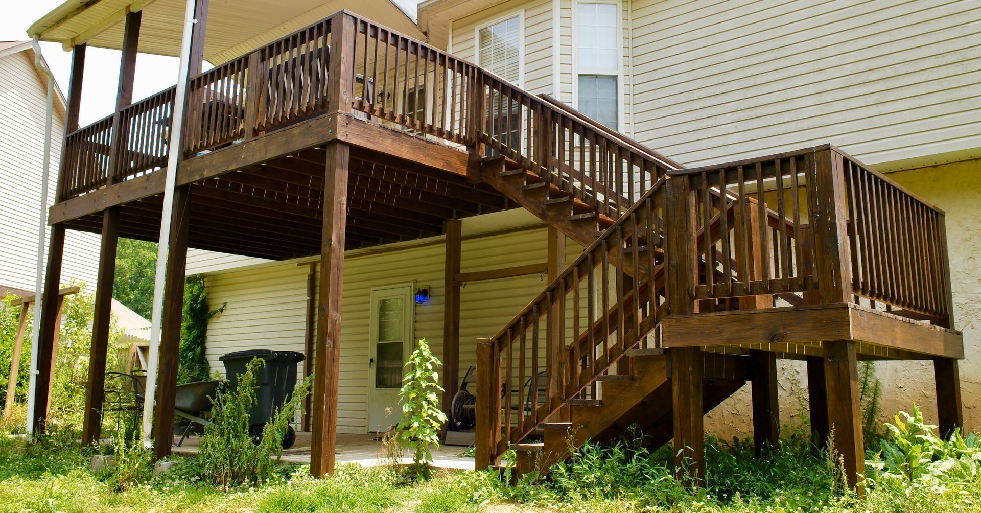 A house with a large wooden deck and stairs