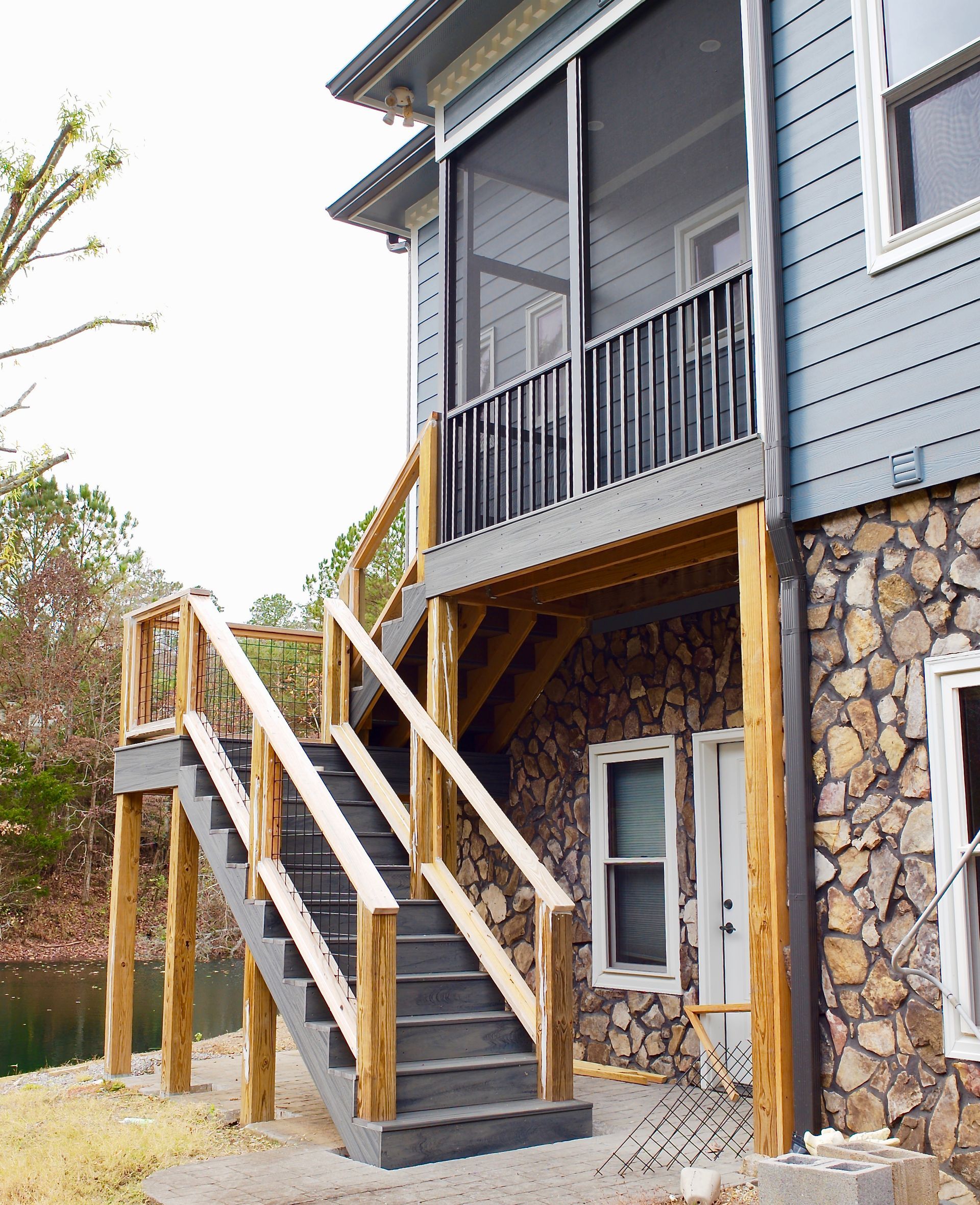 A house with a screened in porch and stairs
