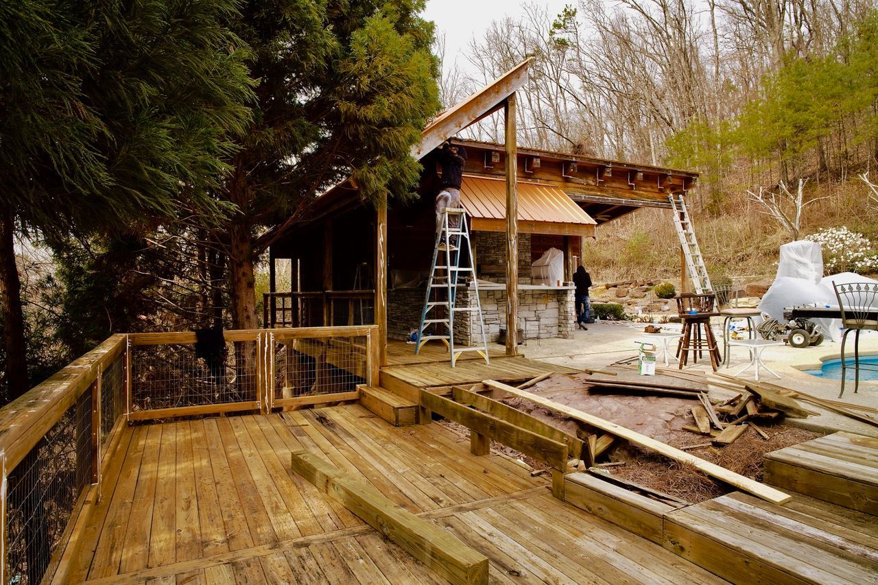 A wooden deck is being built in front of a house.