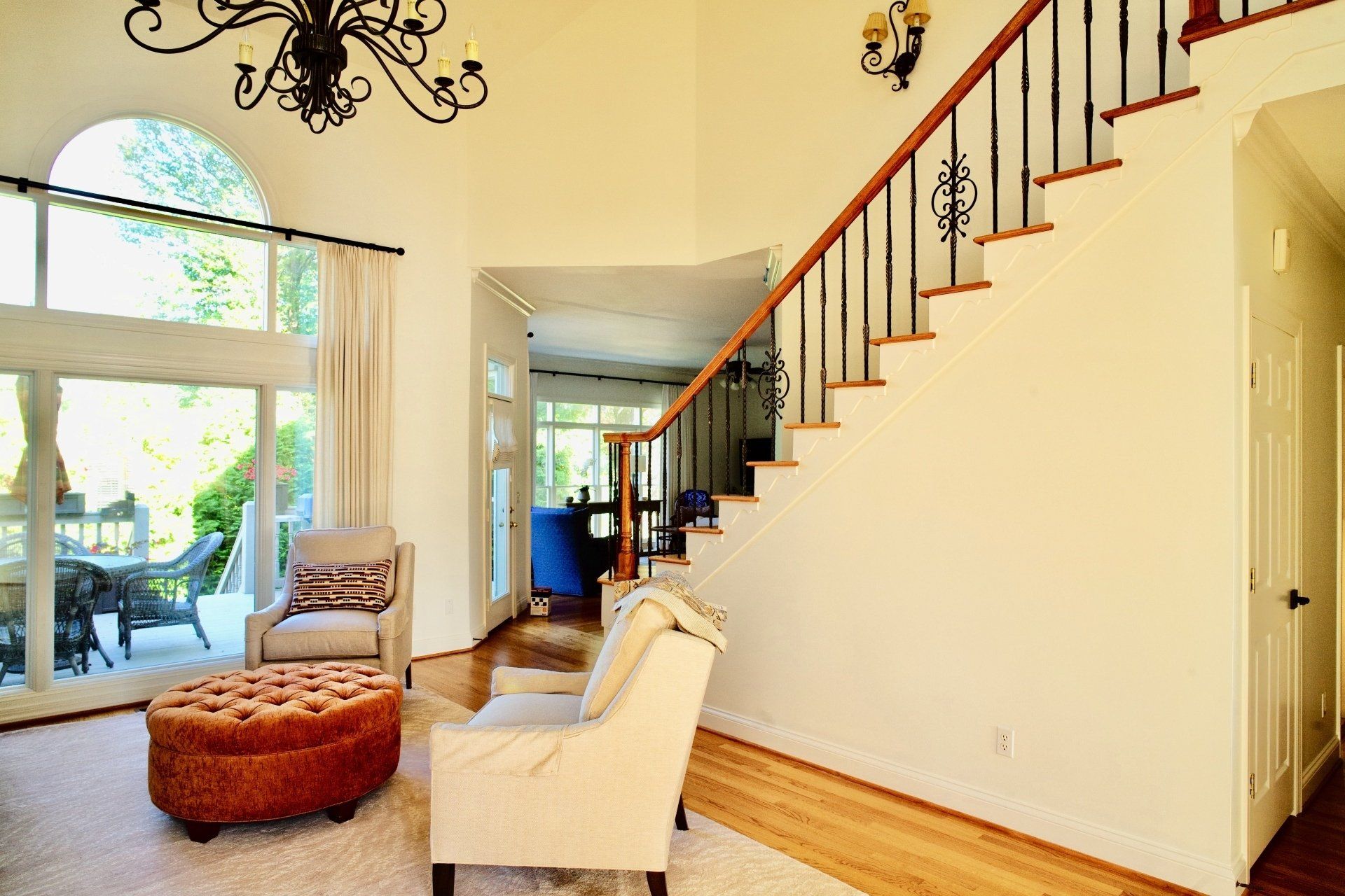 A living room with stairs leading up to the second floor