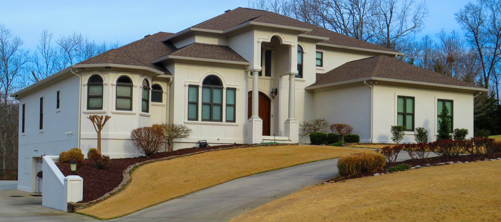 A large white house with a brown roof