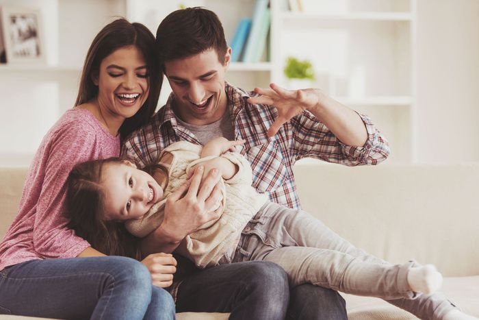 young family having fun together home