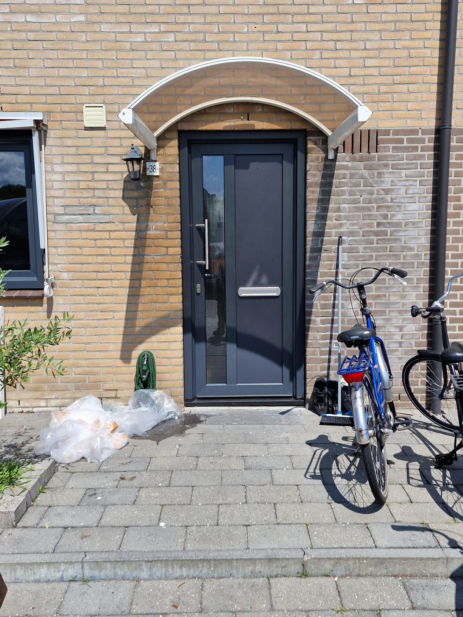 Een fiets staat geparkeerd voor een bakstenen gebouw.