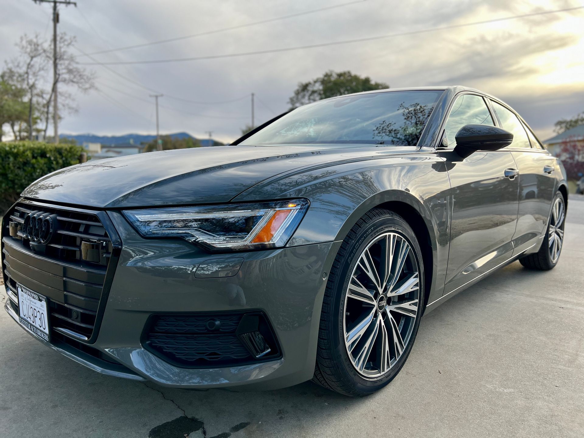 A gray audi a6 is parked in a parking lot.