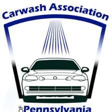 Car wash logo: Car being washed under spraying water within blue arch, with 