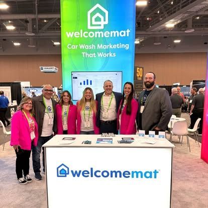 People stand at a trade show booth promoting