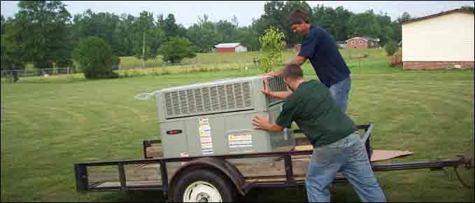 Workers Moving Air Conditioner — Manchester, TN — Shelton's Heating & Cooling
