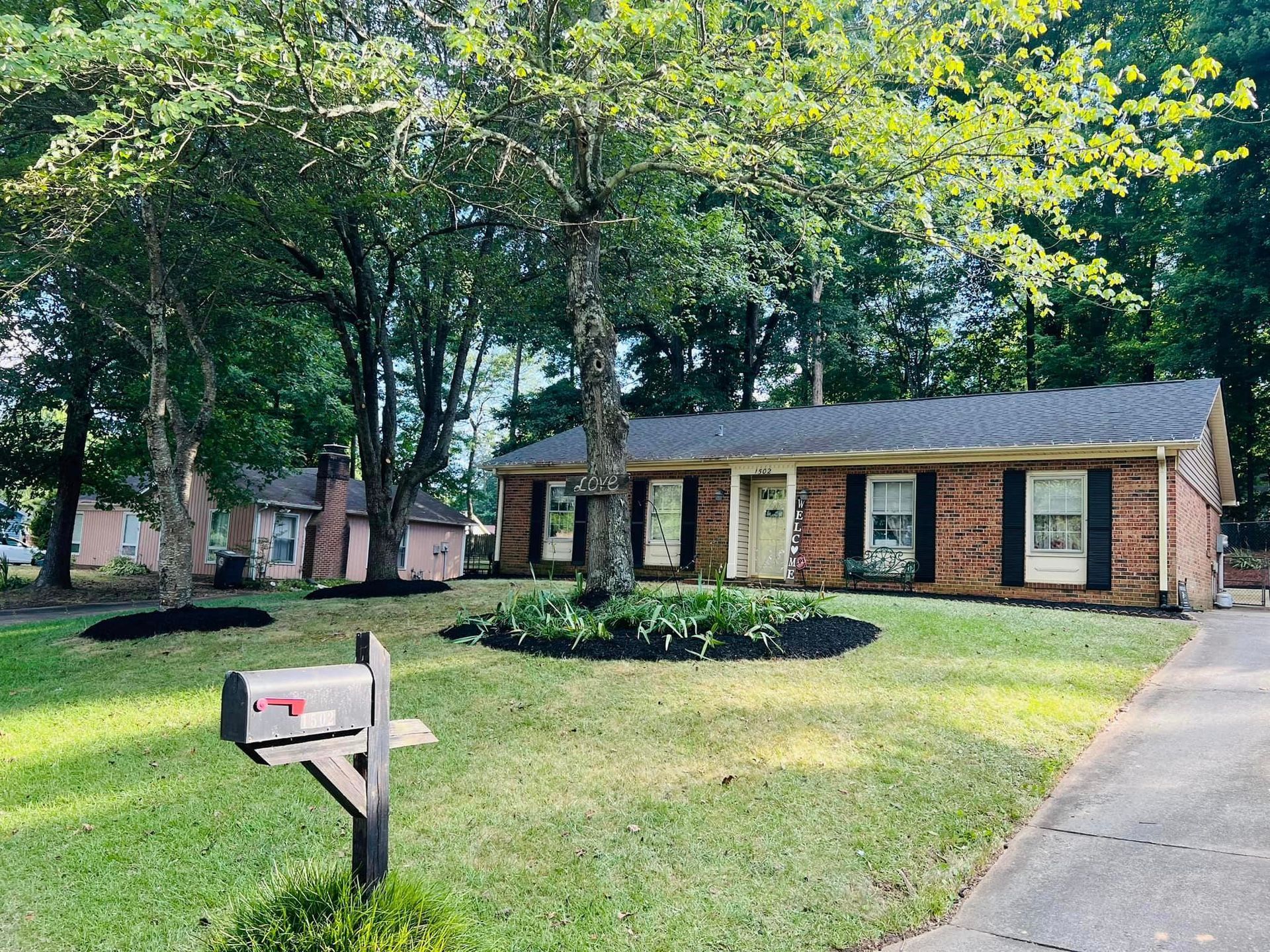 A brick house with a mailbox in front of it