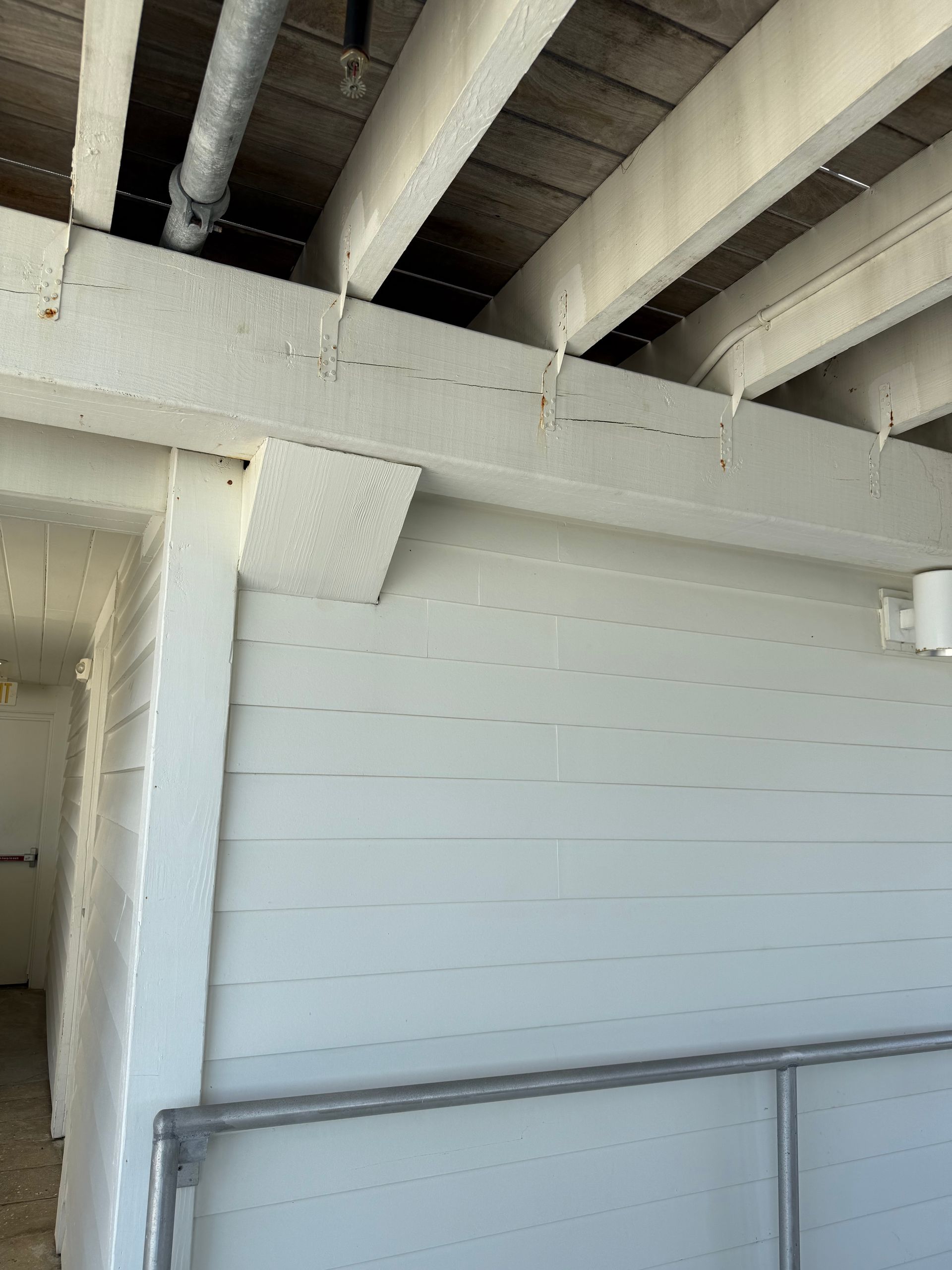 White painted ceiling beams and support structures.