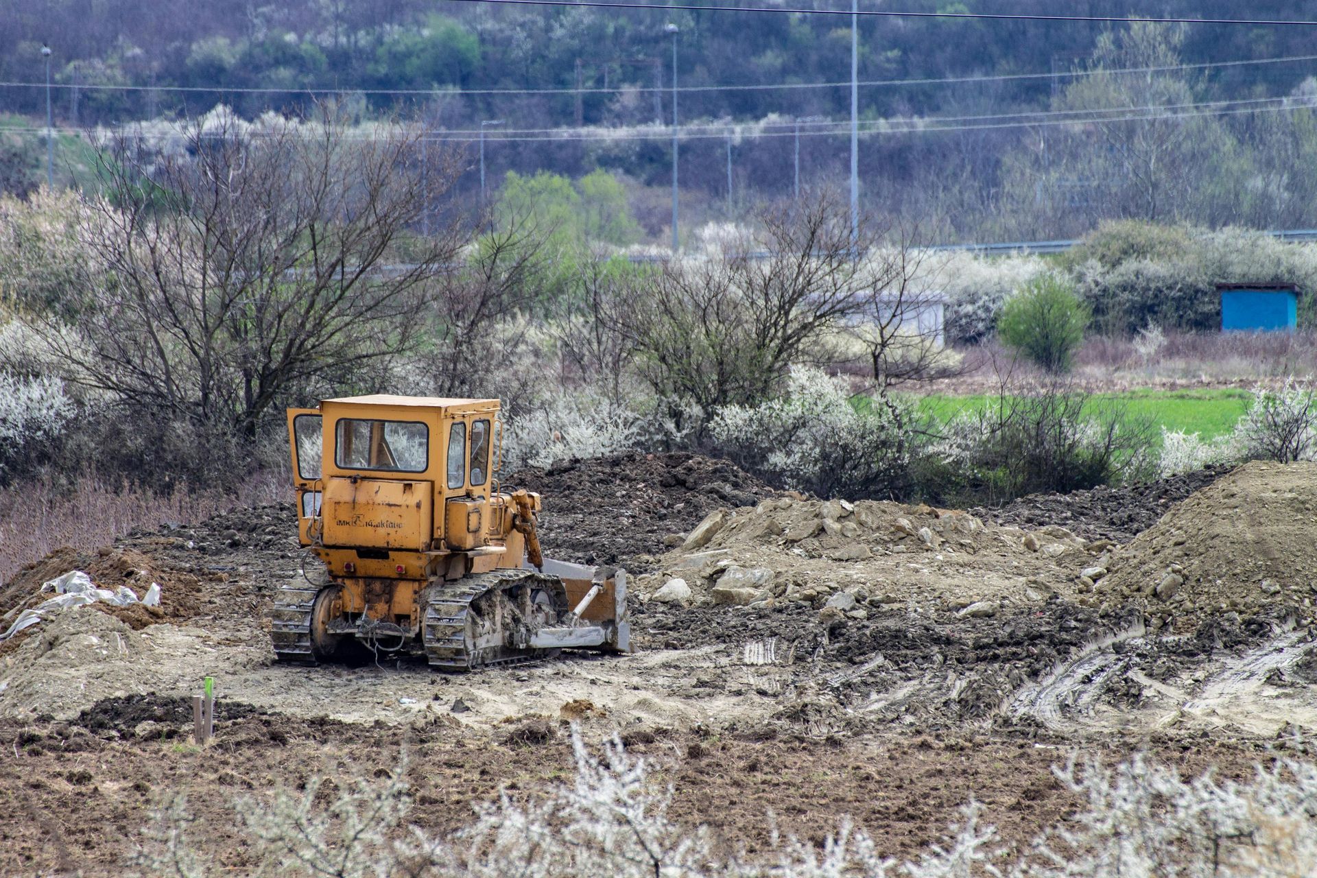 Site preparation bulldozer clearing land and performing ground prep work for construction project