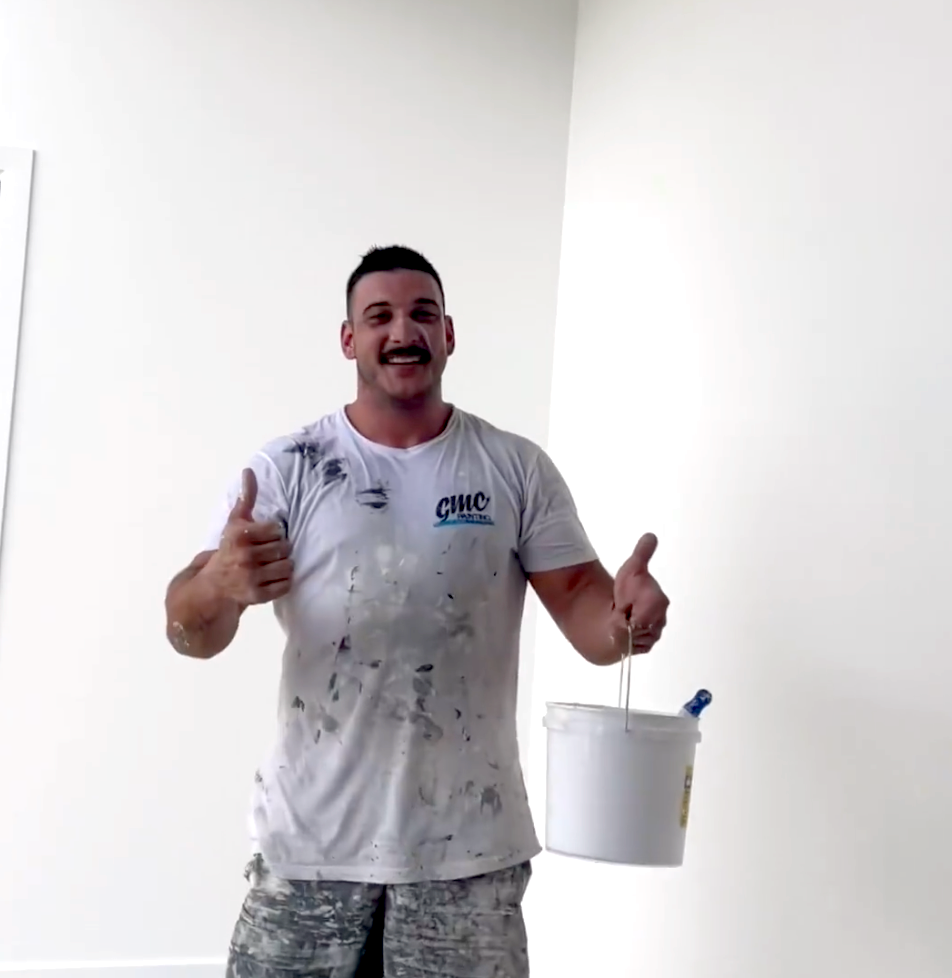 Man holding a paint bucket — Professional Painter on the Gold Coast, QLD