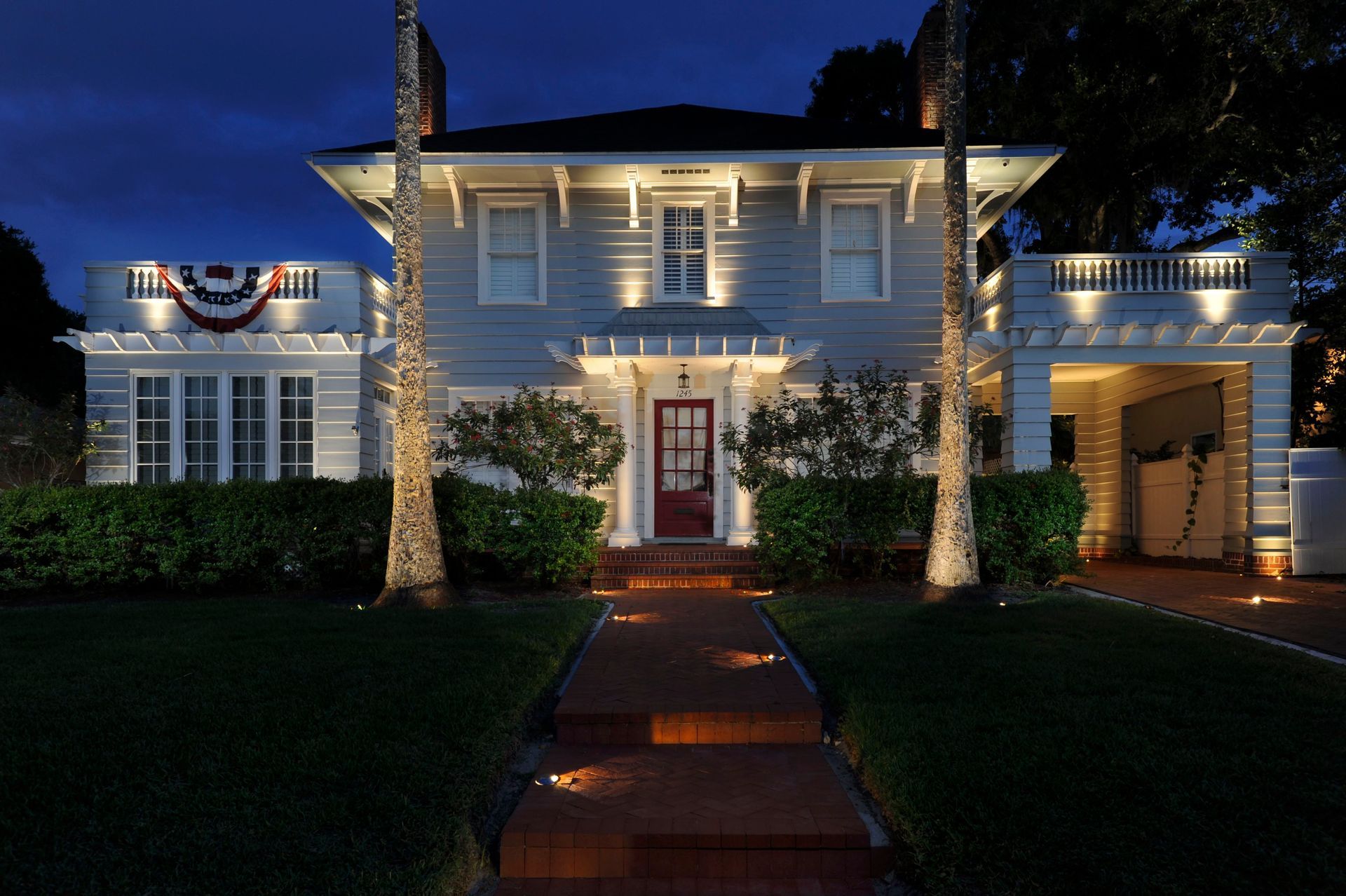 The front of a house is lit up at night